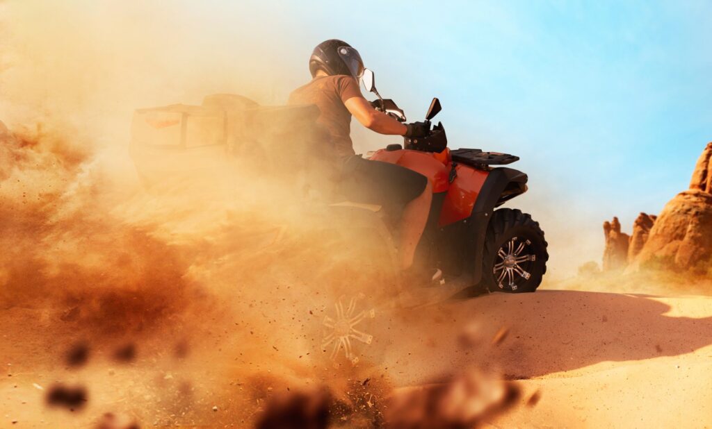 atv riding in sand quarry dust clouds quad bike
