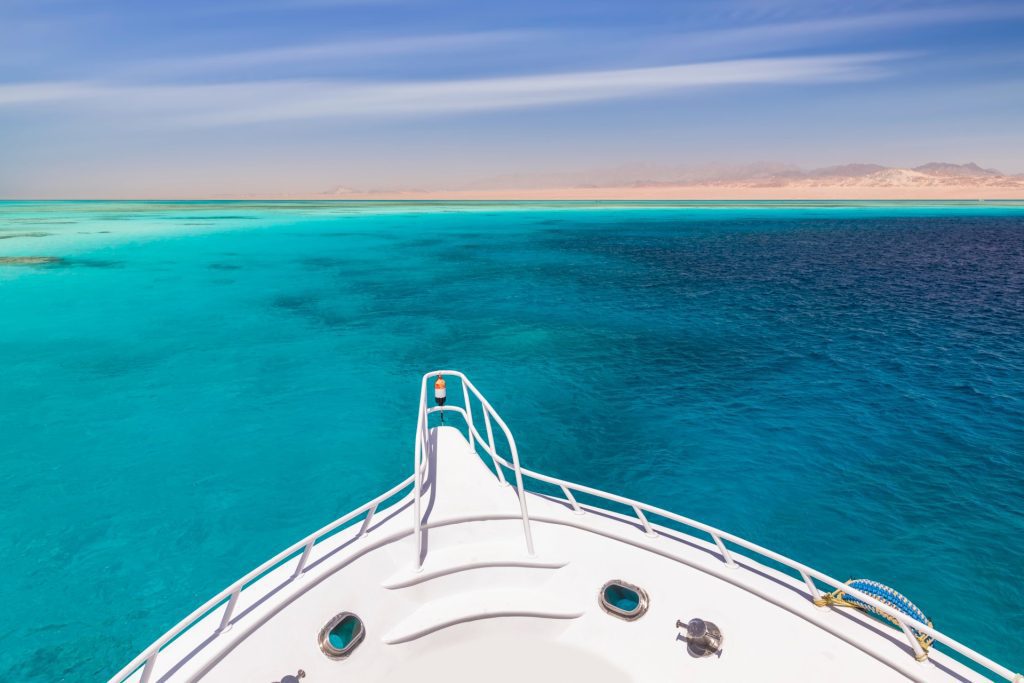 Cruise yacht in clear water near a coral reef