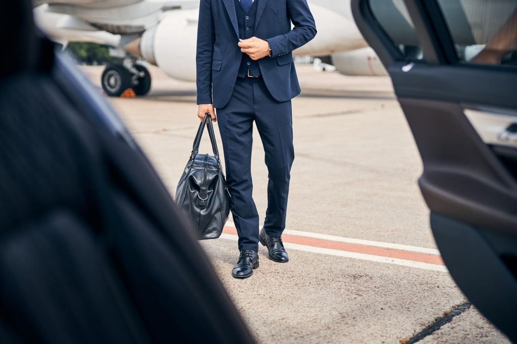 stylish-businessman-looking stylish walking towards car going business trip