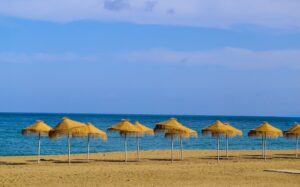 Red Sea Hurghada beach with turquoise waters and colorful parasols, ideal summer holiday destination in Egypt